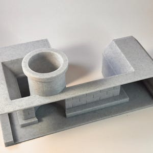 Peut inclure: Maquette architecturale grise avec un puits cylindrique, un pont et une structure rectangulaire. Le modèle a une surface texturée et est fait d'un matériau gris clair. La conception comprend des marches et une section incurvée.