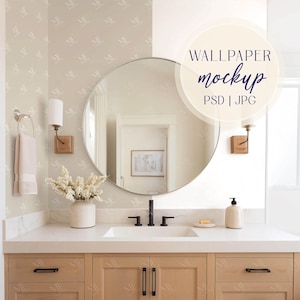 May include: A bathroom interior with a large round mirror, a white countertop, and light wood cabinetry. The image includes a sink, faucet, soap dispenser, and a vase of white flowers. The text "WALLPAPER mockup PSD | JPG" is visible.