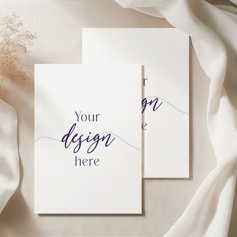 May include: Two blank white cards with a light grey background. The top card has the text "Your design here" in dark blue cursive writing. The bottom card has the text "Your design here" in dark blue cursive writing.