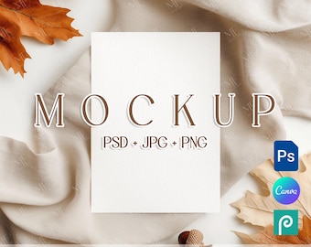 May include: A white card with the word "MOCKUP" in brown letters. The card is on a beige cloth with fall leaves and acorns. Text below the word reads "PSD + JPG + PNG". Icons for Photoshop, Canva, and Photopea are visible.