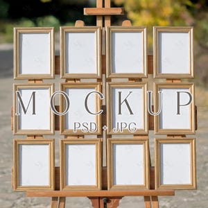 May include: A wooden easel displaying a grid of twelve gold-framed rectangular mockups. The frames have a decorative border and white interiors. The word "MOCKUP" is displayed in large letters across the center, with "PSD + JPG" below.