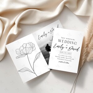 May include: Three white wedding invitation cards. One card features a black and white floral line drawing. Another card has a black and white photo. The third card has the text "You're invited to the WEDDING of Emily & David".