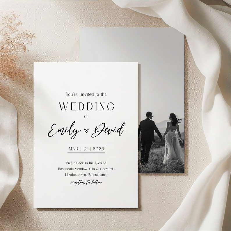 May include: A wedding invitation featuring a black and white photograph of a couple walking away from the camera. The invitation text reads "You're invited to the wedding of Emily & David, MAR | 12 | 2025, Five o'clock in the evening, Rosendale Meadow Villa & Vineyards, Elizabethtown, Pennsylvania, reception to follow."