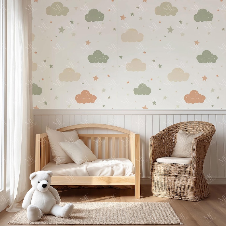 May include: A nursery scene featuring a light wood crib, a woven wicker chair, and a large white teddy bear. The wall is decorated with a cloud and star pattern in pastel colors. A beige rug sits on the wooden floor.