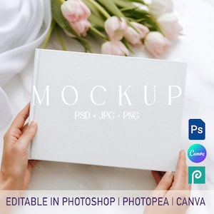 May include: A white book mockup with the word "MOCKUP" in large, elegant font. The text "PSD + JPG + PNG" is below. The bottom of the image reads "EDITABLE IN PHOTOSHOP | PHOTOPEA | CANVA". Pink tulips are in the background.