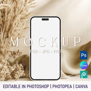 May include: A white phone mockup with a black border, set against a backdrop of beige fabric and dried pampas grass. The text "MOCKUP" is visible above the phone, along with the words "PSD JPG PNG".