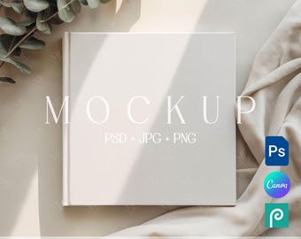 May include: A square, off-white book mockup with the word "MOCKUP" in a light font. The text "PSD + JPG + PNG" is below. The words "EDITABLE IN PHOTOSHOP | PHOTOPEA | CANVA" are at the bottom. A leaf and fabric are in the background.