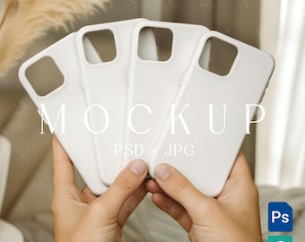 May include: Four white phone cases are held in a person's hands. The word "MOCKUP" is printed in large, elegant letters across the cases. Below the word "MOCKUP" are the words "PSD + JPG". The cases are a solid, matte white.