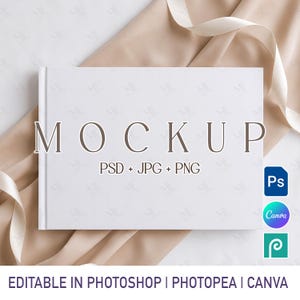 May include: A horizontal white book mockup featuring the text MOCKUP PSD + JPG + PNG centered on the cover. The book is positioned against a soft beige fabric background. Icons for Photoshop, Canva, and Photopea are visible on the right side.
