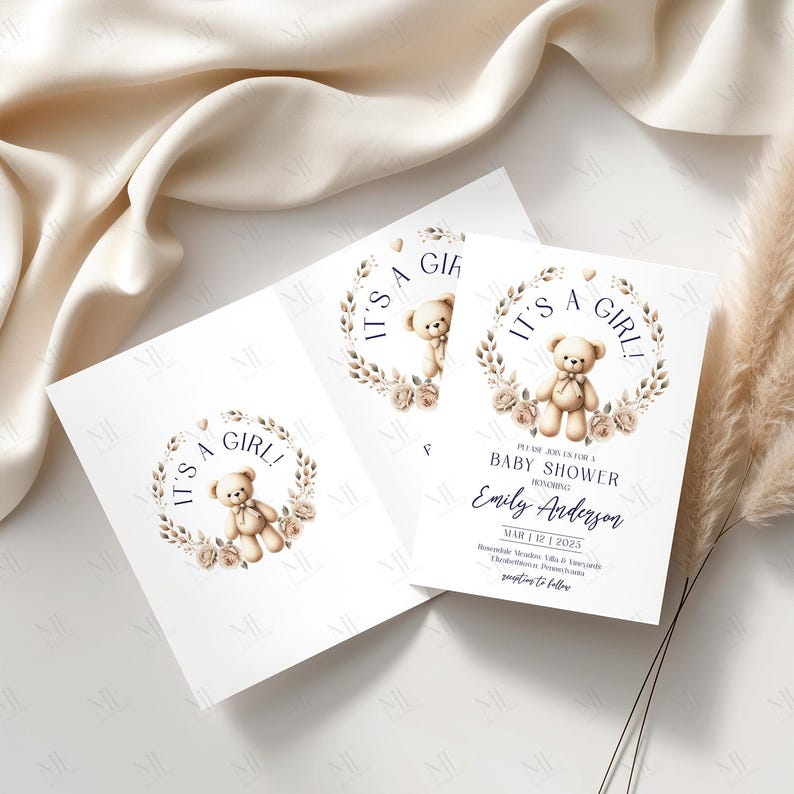 May include: Baby shower invitations with a teddy bear design. The invitations feature a teddy bear illustration inside a floral wreath, with the text "IT'S A GIRL!" and event details. The design is in soft, neutral colors.
