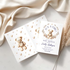 May include: Baby shower invitations with a teddy bear theme. The invitations feature a watercolor teddy bear, hearts, and the text "It's a Girl!" and "Baby Shower". The invitations are in soft neutral colors.