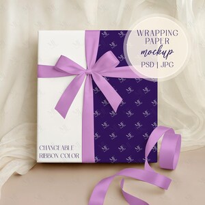 May include: A wrapped gift box with a white and purple design. The box is tied with a lavender ribbon and bow. The text "WRAPPING PAPER mockup PSD | JPG" is visible, along with "CHANGEABLE RIBBON COLOR".
