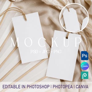 May include: White rectangular mockup tags with twine strings, arranged on a neutral-toned background. The word "MOCKUP" is displayed in large, capital letters. Text below indicates compatibility with PSD, JPG, and PNG formats. Icons for Photoshop, Canva, and Photopea are also visible.