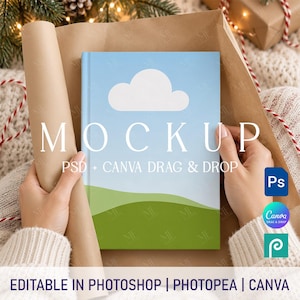May include: A rectangular book mockup featuring a light blue sky with a single white cloud and a green rolling hill landscape. The cover displays the text MOCKUP PSD + CANVA DRAG & DROP. The design is presented as an editable digital file template.