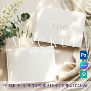May include: Two white hardcover books, one with "11x8" printed on the cover, are displayed on a neutral background. The word "MOCKUP" is overlaid on the image. Text below reads "PSD + JPG + PNG" and "EDITABLE IN PHOTOSHOP | PHOTOPEA | CANVA".