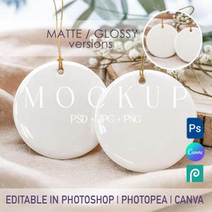 May include: Two blank white circular ceramic ornaments with gold hanging strings. The image features text overlays including MATTE / GLOSSY versions, MOCKUP, PSD + JPG + PNG, and EDITABLE IN PHOTOSHOP | PHOTOPEA | CANVA, along with software icons.