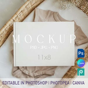 May include: A white book mockup with the word "MOCKUP" in large, elegant font. The book is 28x20 cm, resting on a beige onesie. The image includes text: "PSD + JPG + PNG" and "EDITABLE IN PHOTOSHOP | PHOTOPEA | CANVA".