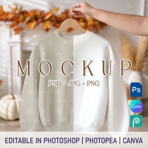 May include: A sweatshirt mockup, split into beige and white halves, suspended from a wooden hanger. The word "MOCKUP" is displayed in large, brown letters. Text below reads "PSD + JPG + PNG". Icons for Photoshop, Canva, and Photopea are visible.