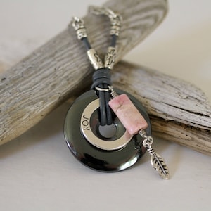 Hematite Donut Necklace: Rhodochrosite, Feather Charm, Leather Cord