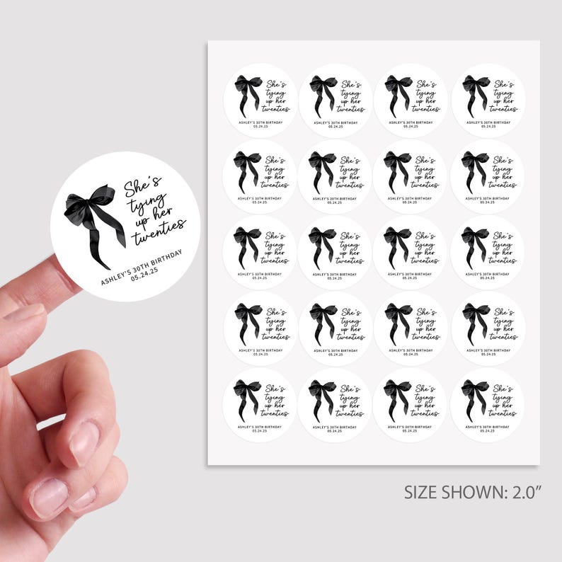 May include: A sheet of 2-inch round stickers with a black and white design. The stickers feature a black bow with a white outline and the text "She's tying up her twenties". The text "Ashley's 30th Birthday 05.24.25" is also included on the stickers.