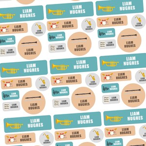 May include: A pattern of personalized labels with musical instrument illustrations and the name "LIAM HUGHES". The labels feature trumpets, saxophones, drums, clarinets, and musical notes in various shapes and colors.