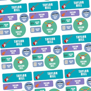 May include: A pattern of stickers with the text "TAYLOR HILL" and musical instrument graphics. The stickers are rectangular and circular, in shades of blue, purple, and green. Instruments include guitars, drums, and keyboards.