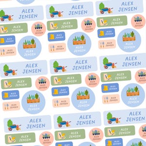 May include: A pattern of personalised labels, each displaying the name "ALEX JENSEN". The labels are adorned with gardening-themed illustrations, such as wheelbarrows, wellington boots, and plants, in various shapes and sizes, perfect for organisation.