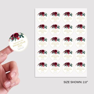 May include: A sheet of 20 round, 5 cm diameter, white sticker labels with a gold border. Each label features a watercolour illustration of red and white flowers with green leaves and the text "Homemade by Emily Spiced Pear Jam".