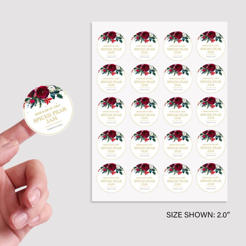 May include: A sheet of 20 round, 5 cm diameter, white sticker labels with a gold border. Each label features a watercolour illustration of red and white flowers with green leaves and the text "Homemade by Emily Spiced Pear Jam".