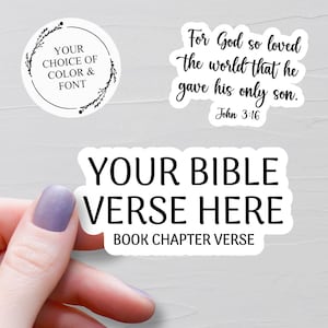 May include: Three white stickers with black text. One circular sticker reads YOUR CHOICE OF COLOUR & FONT. One sticker features the text For God so loved the world that he gave his only son. John 3:16. One sticker reads YOUR BIBLE VERSE HERE BOOK CHAPTER VERSE.