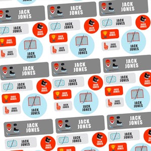 May include: A repeating pattern of stickers with a hockey theme. The stickers feature the name "JACK JONES" along with hockey-related graphics such as helmets, skates, nets, and trophies. The color scheme includes red, blue, and gray.