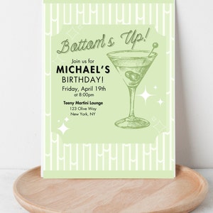 May include: A green and white invitation card with the text "Bottom's Up!" and "Join us for MICHAEL'S BIRTHDAY!"  The invitation is for a party on Friday, April 19th at 8:00pm at the Teeny Martini Lounge, 123 Olive Way, New York, NY. The invitation features a drawing of a martini glass.
