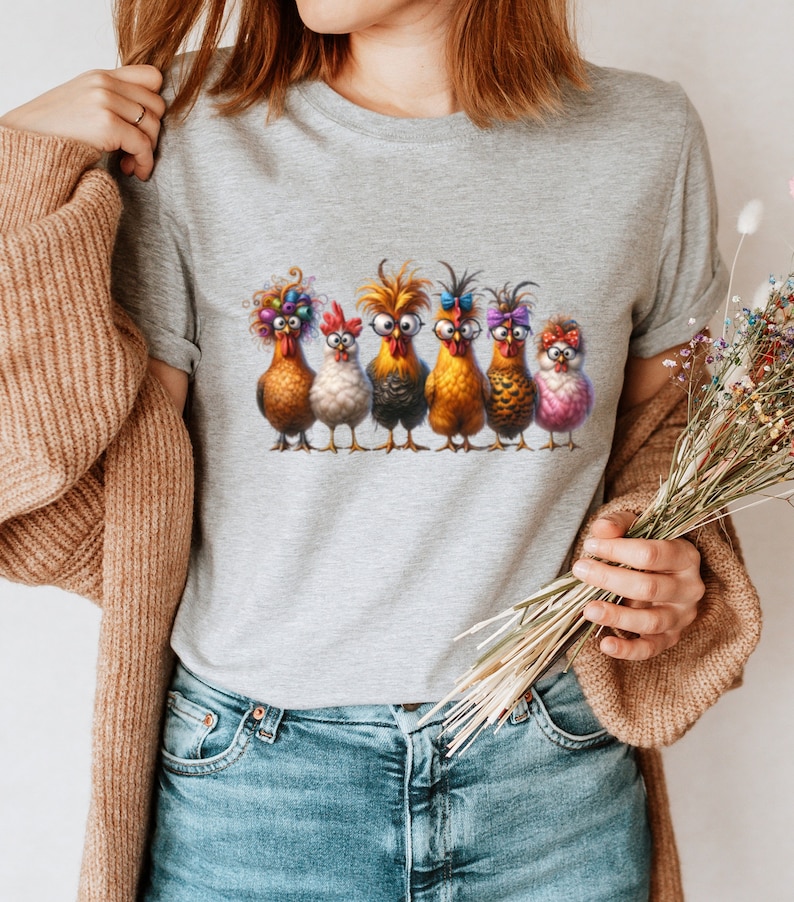 May include: A gray t-shirt with a graphic of six chickens wearing glasses and various accessories. The chickens are standing in a row and looking at the viewer.
