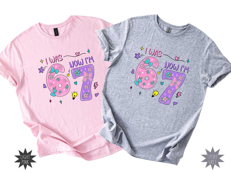 May include: A light pink t-shirt and a sport grey t-shirt, each featuring a graphic print with the text "I WAS" and "NOW I'M" surrounding the numbers 6 and 7, decorated with colorful bows, flowers, stars, a lightbulb, and lightning bolt icons.