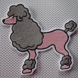 May include: Embroidered poodle patch in a side profile. The dog has a grey body, pink legs and snout, and a black outline. The patch is bordered with white and set against a dotted background.