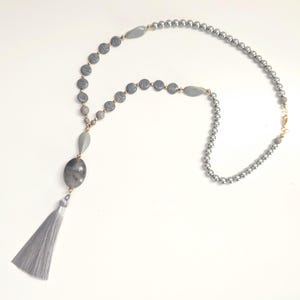 Dove grey tassel necklace. Long necklace with grey glass and gold plated beads with a luxury silky tassel. HoC Sp. Au.