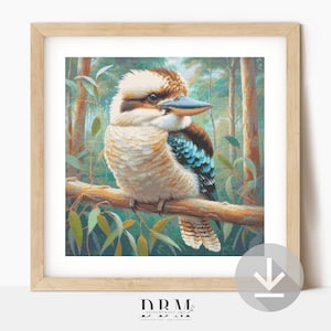 May include: A framed print of a kookaburra bird on a branch. The bird has a white and brown head, a blue beak, and turquoise wing accents. The background shows a forest scene with green foliage and tall trees. The frame is light brown.