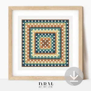 May include: A framed cross-stitch artwork featuring a geometric square design. The design uses a palette of teal, brown, and yellow, creating a layered, patterned effect. The artwork is in a light-colored wooden frame.
