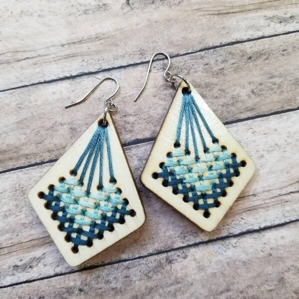 Kite shaped wooden dangle earrings with shades of blue cross stitch