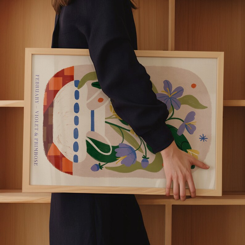 May include: A framed print with a colorful abstract design featuring flowers, geometric shapes, and the text "FEBRUARY - VIOLET & PRIMROSE".