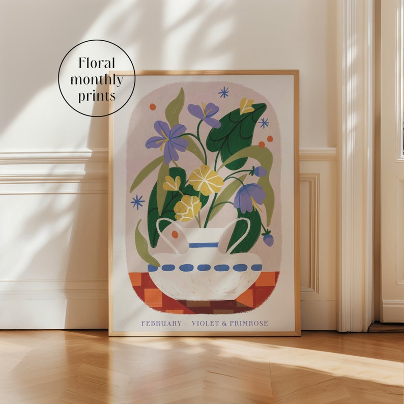 May include: A framed illustration of a white vase with a blue and white pattern filled with purple, yellow, and green flowers. The text "FEBRUARY - VIOLET & PRIMROSE" is at the bottom of the illustration.