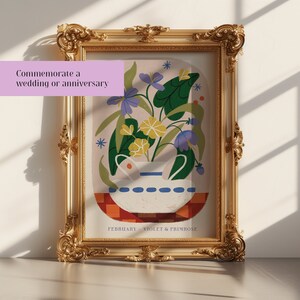 May include: A framed illustration of a white vase with purple and yellow flowers. The vase is sitting on a red and white checkered surface. The text "FEBRUARY - VIOLET & PRIMROSE" is at the bottom of the image.