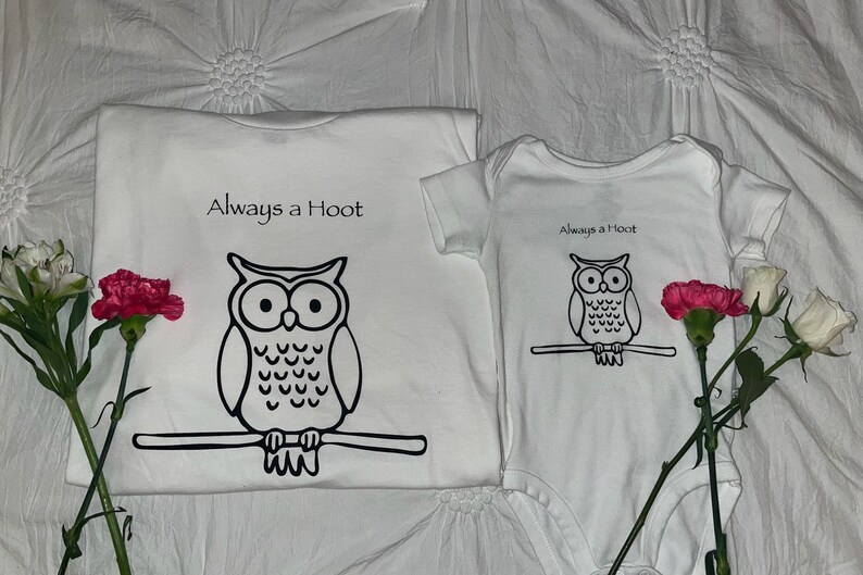May include: Two white t-shirts with an owl graphic and the text "Always a Hoot". The larger shirt has a larger owl graphic.