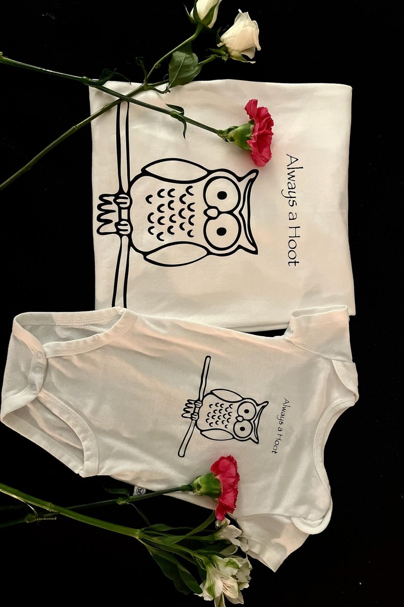 May include: Two white t-shirts with a black owl graphic and the text "Always a Hoot".