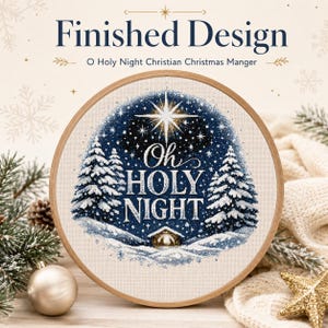 May include: A circular wooden embroidery hoop containing a cross-stitch design of a snowy winter landscape with pine trees, a star, and a small manger. The text "Oh Holy Night" is stitched in white in the centre against a dark blue starry sky.