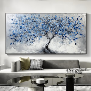 May include: A large abstract painting of a blue tree with a white background. The tree has many branches and leaves, and the painting is framed in black.