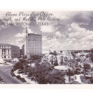 May include: A black and white vintage postcard depicting a view of Alamo Plaza in San Antonio, Texas. The postcard shows the Post Office, Cenotaph, and the Medical Arts Building. The postcard also shows a street with cars and trees.