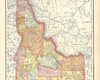 May include: A vintage map of Idaho, showing the state's counties and major cities. The map is in a light brown colour scheme with yellow, orange, and pink accents. The map includes a scale and a legend.