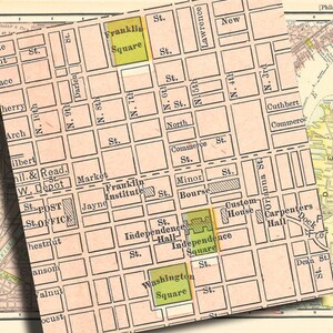 May include: A vintage map of Philadelphia, Pennsylvania, showing the streets and landmarks of the city's historic center. The map highlights key locations like Franklin Square, Independence Hall, and Independence Square. The map is printed in shades of pink, green, and yellow.