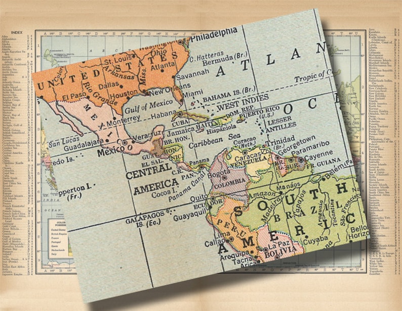 May include: A vintage map of North and South America, with a focus on Central and South America. The map is printed on a light blue background with brown and green borders. The map includes the names of countries, cities, and geographic features.